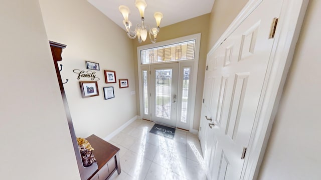 foyer featuring an inviting chandelier and light tile patterned floors