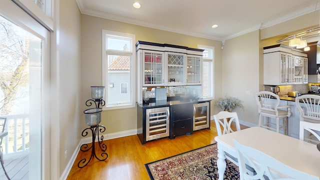 office space featuring light hardwood / wood-style flooring, a wealth of natural light, and crown molding