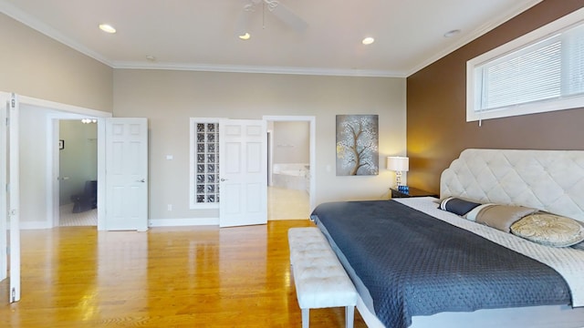 bedroom featuring ceiling fan, hardwood / wood-style flooring, ensuite bath, and ornamental molding