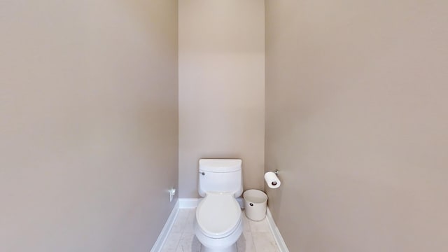 bathroom with tile patterned floors and toilet