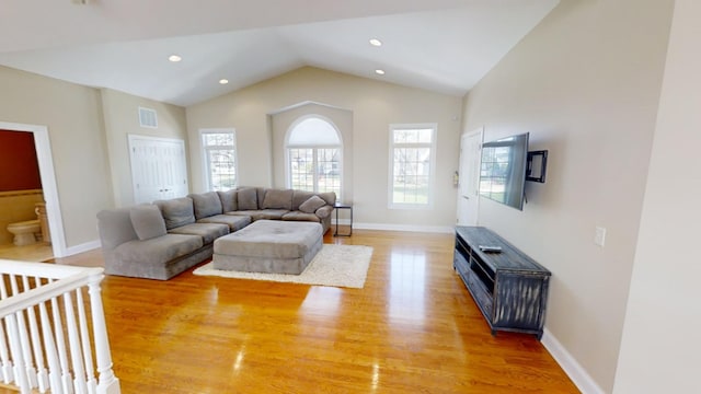 living room with hardwood / wood-style flooring and lofted ceiling