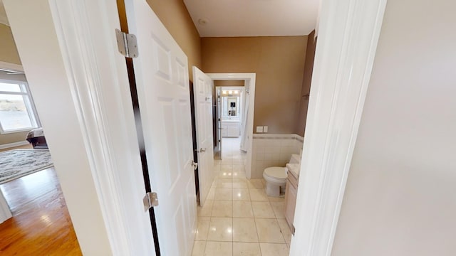 hallway with light hardwood / wood-style floors