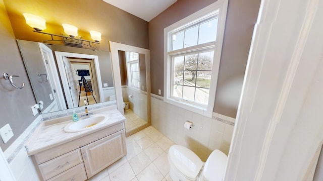 bathroom featuring vanity, tile patterned floors, a wealth of natural light, and toilet