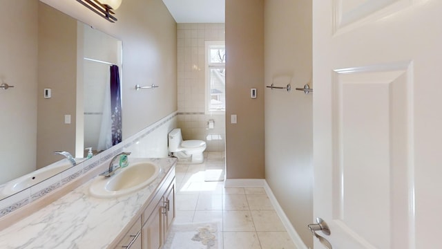 bathroom with vanity, tile patterned flooring, and toilet