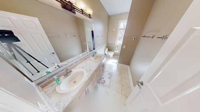 bathroom with tile patterned floors, toilet, and dual bowl vanity