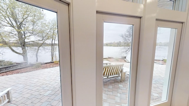 doorway to outside with a water view