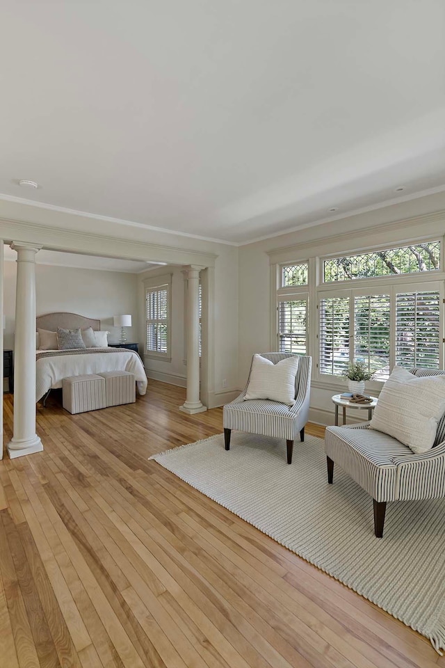 bedroom with light hardwood / wood-style floors and crown molding