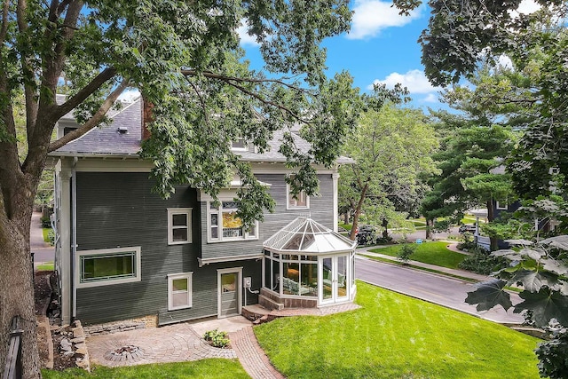 rear view of house with a yard