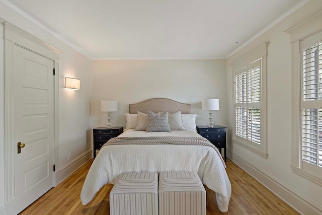 bedroom featuring light wood-type flooring and crown molding