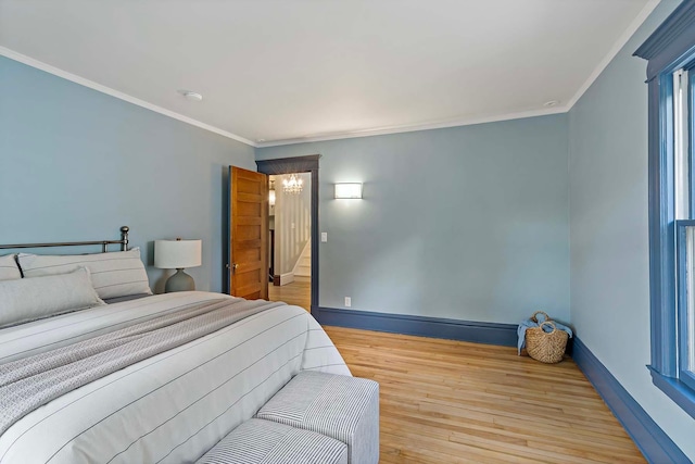 bedroom featuring ornamental molding and light hardwood / wood-style floors