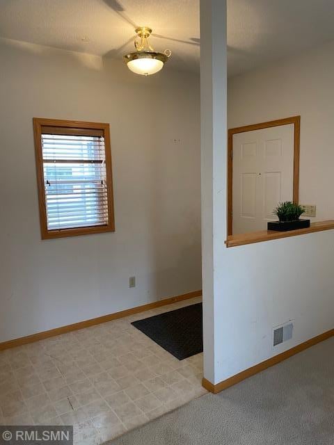 empty room featuring light carpet