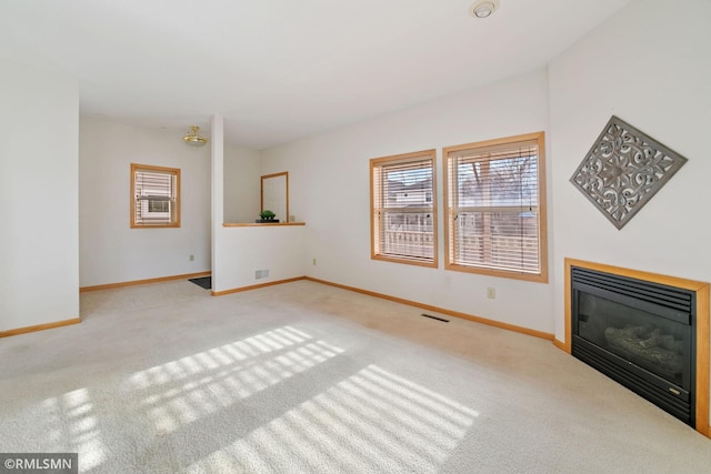 unfurnished living room featuring light carpet