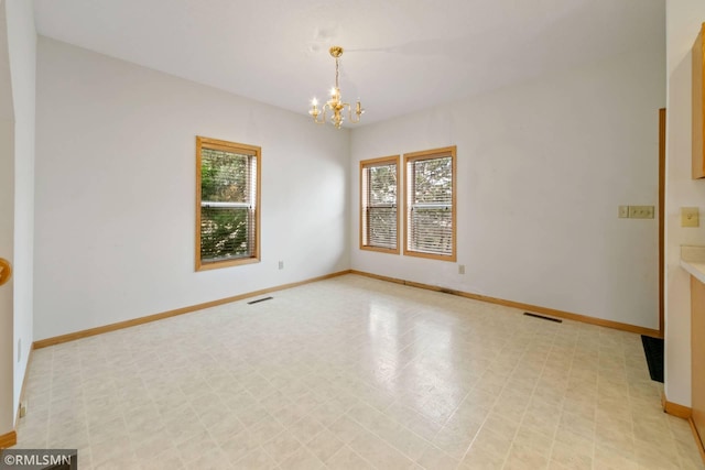 empty room with a notable chandelier