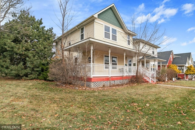 country-style home featuring a front lawn and a porch