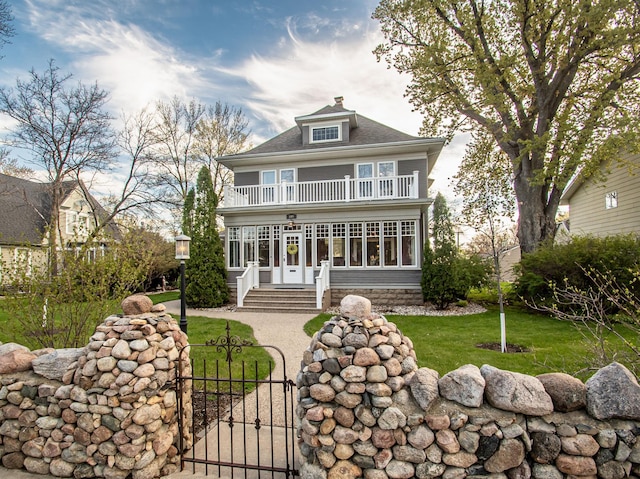 view of front of property featuring french doors and a front lawn