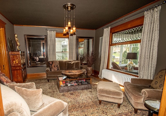 living room with ornamental molding and a chandelier