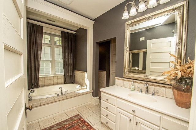 bathroom featuring tile patterned floors, vanity, and a tub to relax in