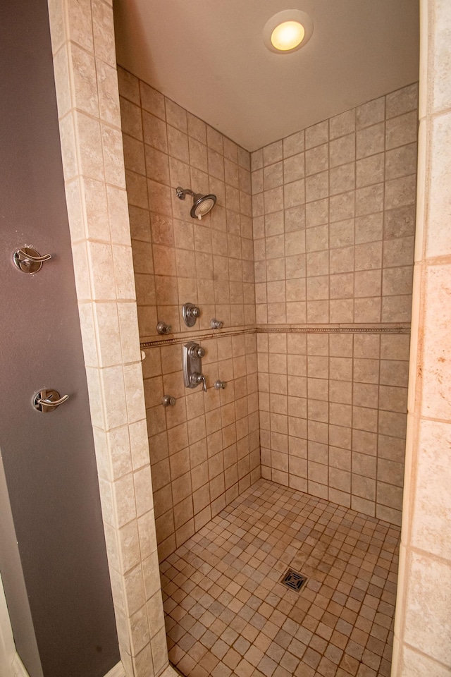 bathroom with a tile shower