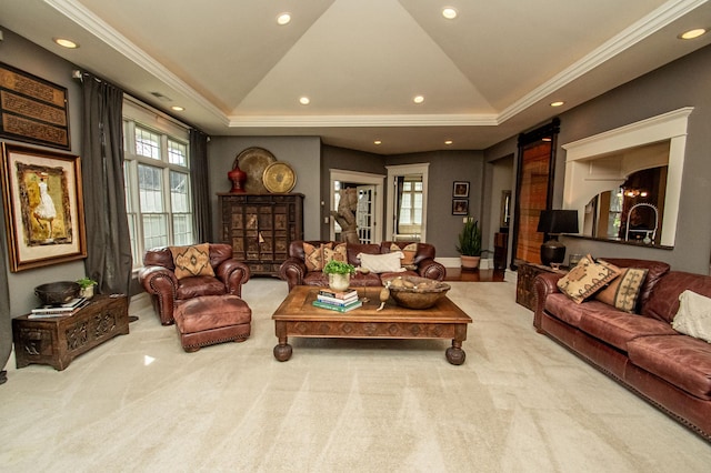 carpeted living room featuring crown molding, a tray ceiling, and a wealth of natural light