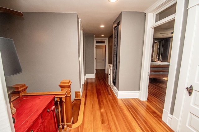 hallway with hardwood / wood-style flooring