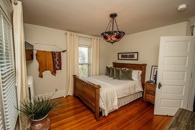 bedroom with dark wood-type flooring