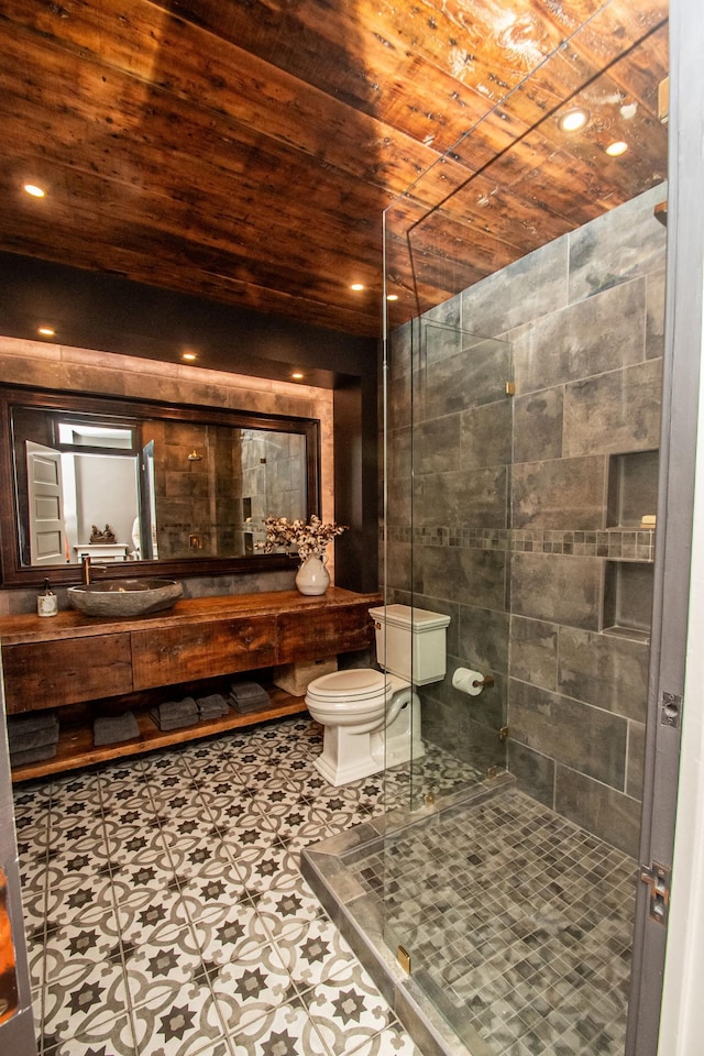 bathroom featuring a shower with door, tile patterned floors, toilet, vanity, and wooden ceiling