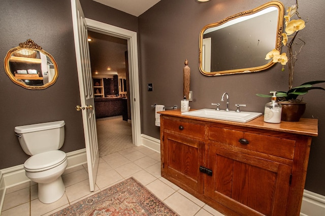 bathroom featuring tile patterned flooring, toilet, and vanity