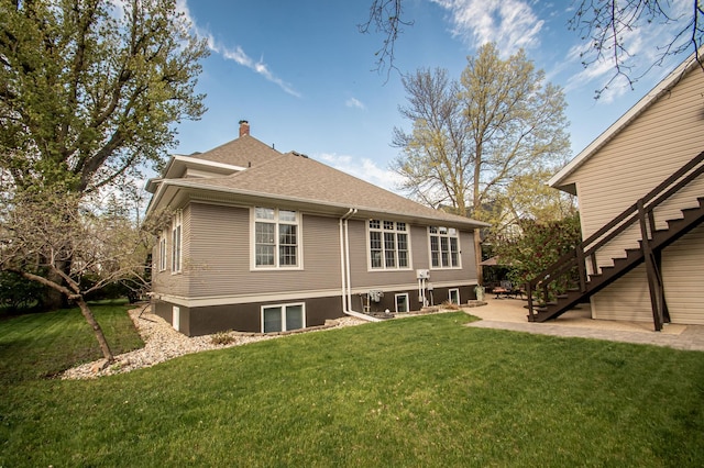 rear view of property with a lawn