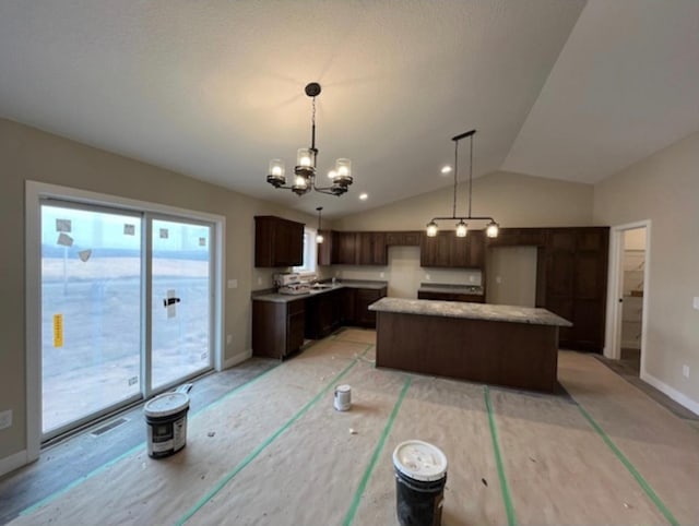 dining space with a chandelier and vaulted ceiling