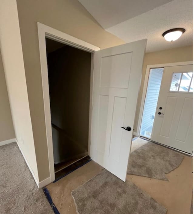 foyer featuring a textured ceiling and concrete flooring