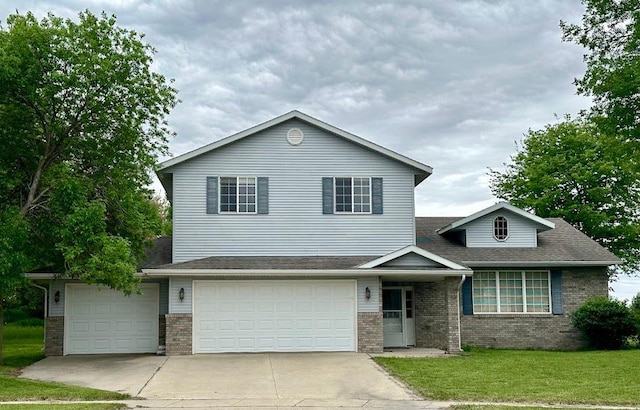 view of front of property with a garage and a front lawn