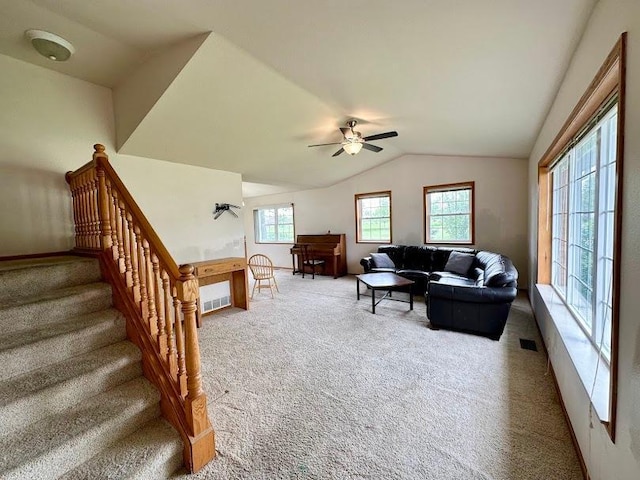 living room featuring lofted ceiling, carpet, and ceiling fan