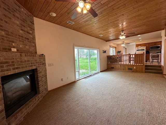 unfurnished living room with ceiling fan, carpet floors, wood ceiling, and a brick fireplace