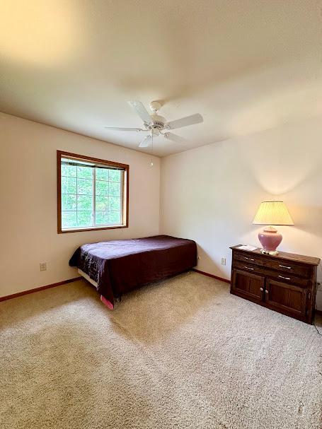 carpeted bedroom featuring ceiling fan