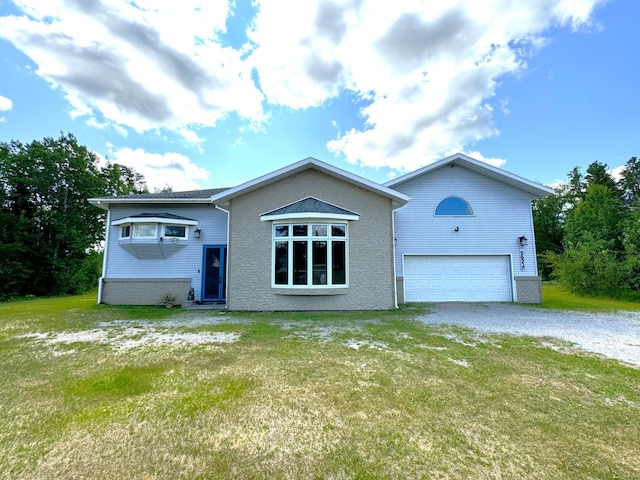 view of front of house featuring a garage, a front yard, and driveway