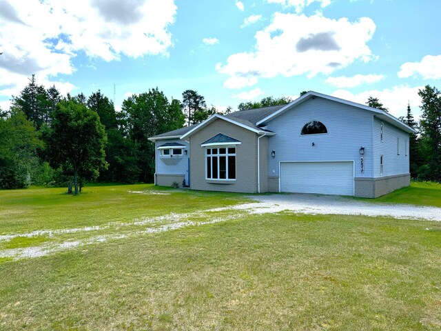 view of front of property featuring a garage and a front lawn