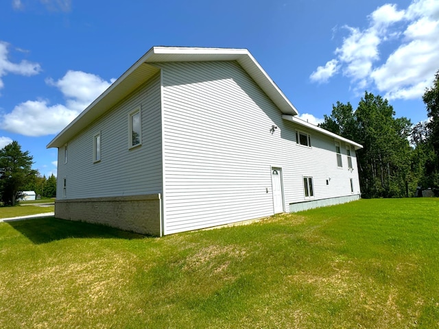 view of side of home with a lawn