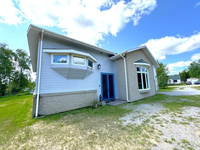 back of property with a lawn