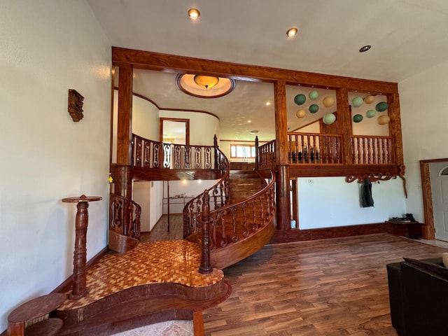 stairway featuring recessed lighting, wood finished floors, and baseboards