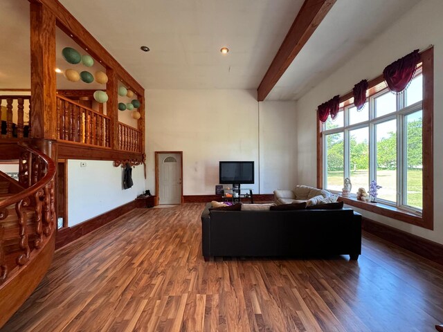 living room with beamed ceiling and hardwood / wood-style flooring