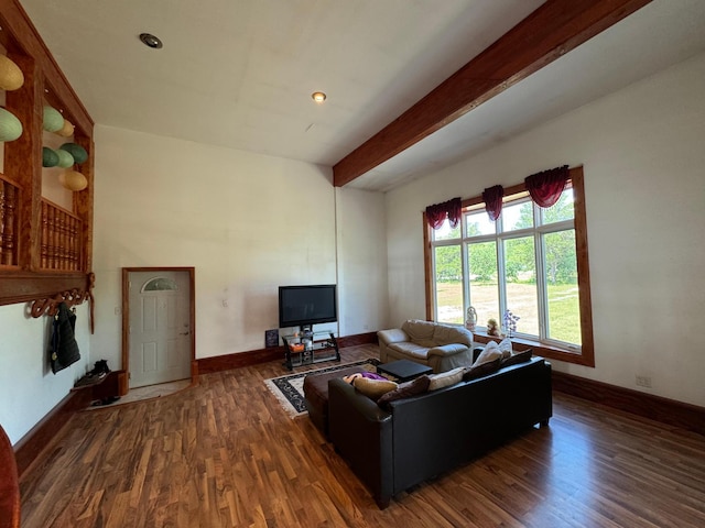 living area with beamed ceiling, baseboards, and wood finished floors