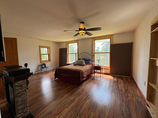 bedroom featuring multiple windows, ceiling fan, and dark wood-type flooring