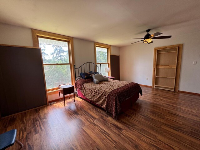 bedroom with dark wood-type flooring and ceiling fan