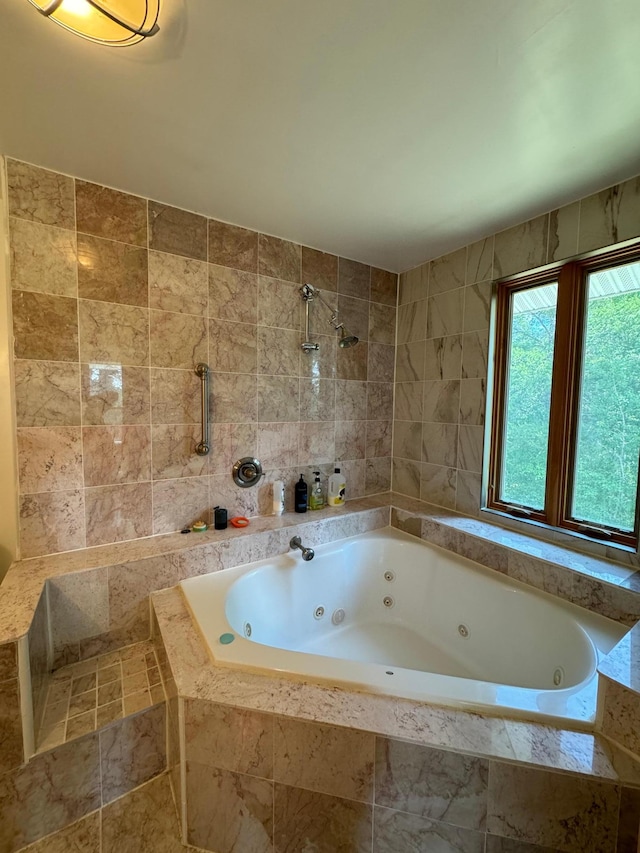 full bathroom featuring tile walls, a jetted tub, and a tile shower