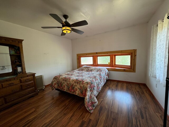 bedroom with ceiling fan, hardwood / wood-style flooring, and radiator heating unit