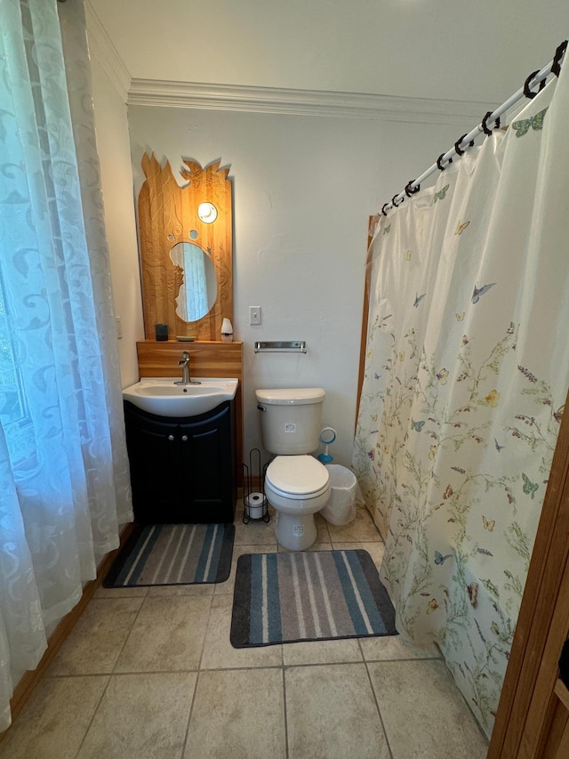 bathroom with toilet, ornamental molding, curtained shower, tile patterned flooring, and vanity