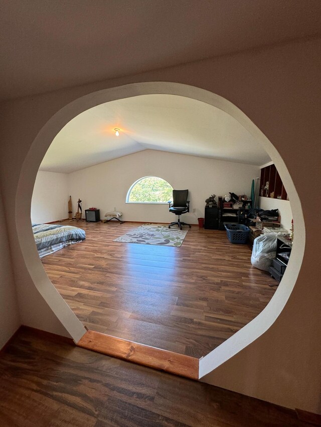 interior space with vaulted ceiling and hardwood / wood-style floors