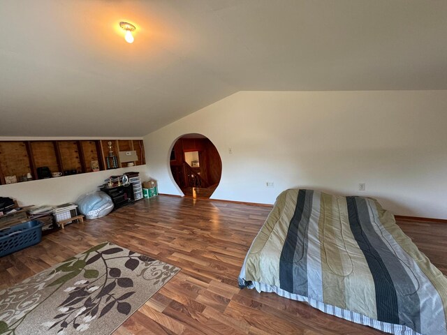 bedroom featuring wood-type flooring and lofted ceiling