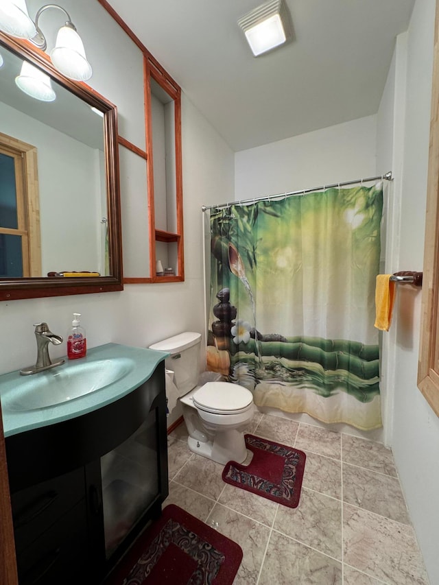 full bath with vanity, shower / tub combo, toilet, and tile patterned flooring