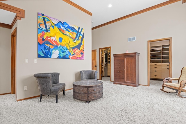 living area with crown molding, carpet flooring, and a high ceiling